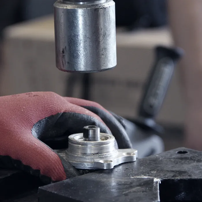 Technician pressing a part in a workshop