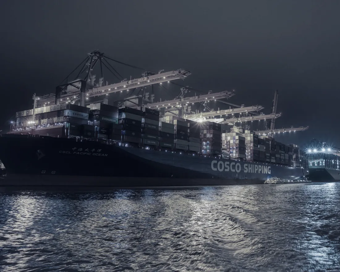 Container ship at a port terminal at night